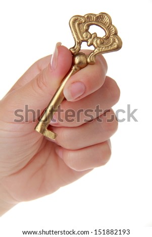 Vintage metal key in a female hand