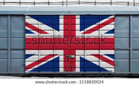 Front view of a container train freight car with a large metal lock with the national flag of United Kingdom.The concept of export-import,transportation, national delivery of goods, rail transportatio