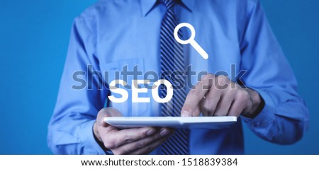 Man using white digital tablet. SEO - Search Engine Optimization