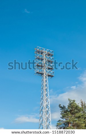 Sport light on blue sky background in stadium