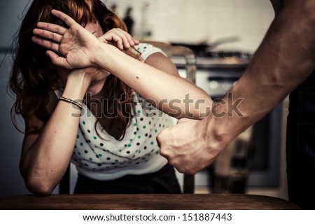 Woman covering her face in fear of domestic violence Royalty-Free Stock Photo #151887443