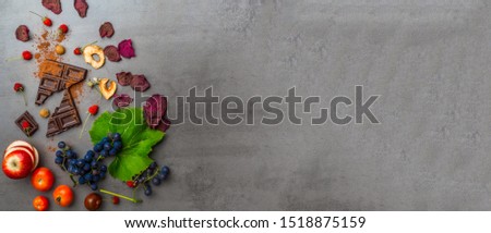 banner of anticancer food, good for cardiovasculas system, fresh ripe grape, dark chocolate, raspberries, tomatoes, apple, beet on concrete background. Food rich in resveratrol, antioxidants Royalty-Free Stock Photo #1518875159