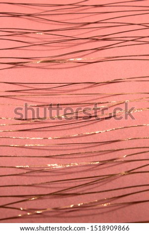 This is a photograph of a geometric design created using Rose gold tape applied onto a Pink paper