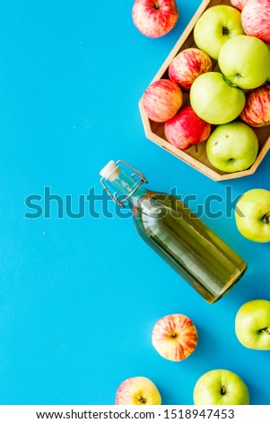 Vinegar made from fresh apple on blue background top view space for text