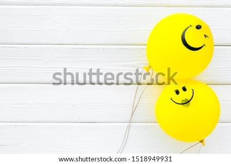 Happiness emotion. Yellow balloon with smile on white wooden background top view space for text