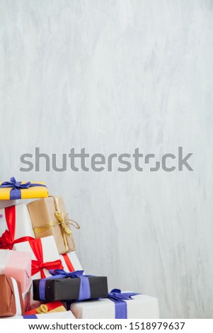 Lots of multicolored birthday presents New Year Christmas on a grey background