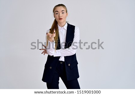 Portrait of a pretty manager girl in a business suit on a white background with long hair. Great makeup, beautiful face. It is in different poses with different emotions.