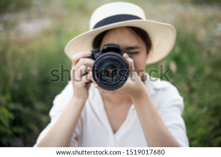 Summer smiling lifestyle portrait of Cheerful woman wanderer having fun in the city in Thailand in evening with camera travel photo of photographer Making pictures in hipster style hat