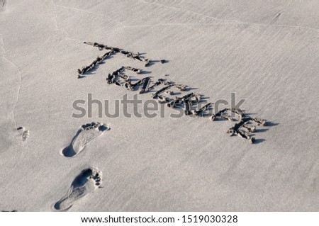 Inscription TENERIFE made on beautiful black beach.