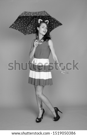 Studio shot of young beautiful woman in black and white
