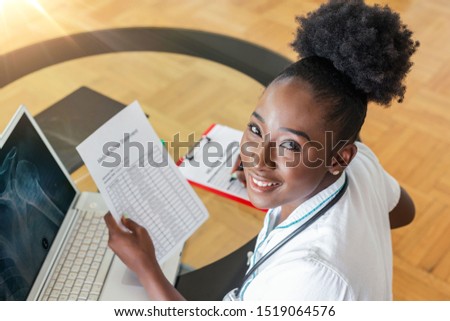 Healthcare costs and fees concept. Top view of smart doctor calculating medical costs in modern hospital. Doctor completing a Medical Claim Form, Stethoscope