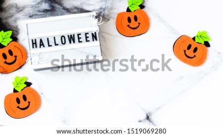 Creative Halloween Day composition flat lay top view holiday celebration black spider web lightbox, orange pumpkins on white paper background copy space Template greeting card design social media