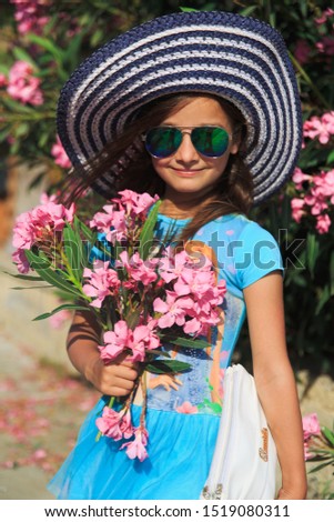 young girl with flowers in the hat