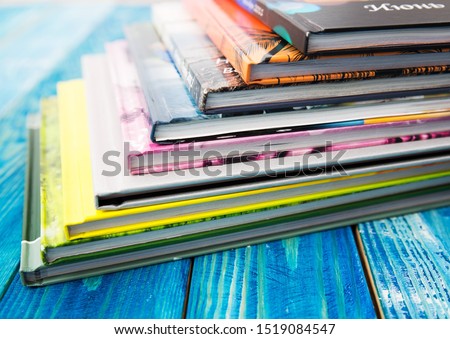 Color photo of large stack of paper books.  Photobook Album with Photos 