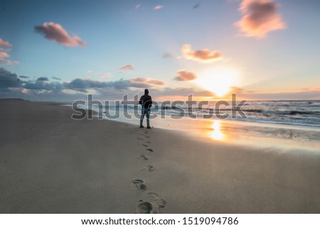 Man on the beach looking at the sea
