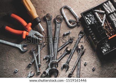 Composition of wrenches and construction tools on a concrete background.