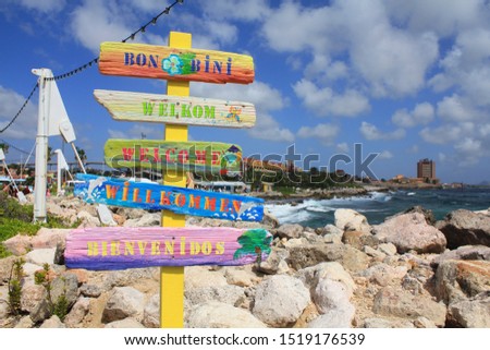 Welcome signs in different languages in Willemstad cruise port, Curacao, Caribbean island.