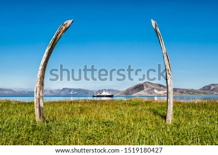 Tourist boat anchored in front of Ittygran Island, Chukotka, Russia Royalty-Free Stock Photo #1519180427