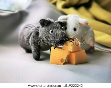 Two cute funny mouse with cheese, a symbol of the year 2020 on the astrological calendar. Photo of children's toys close-up
