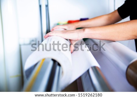 Printing house, service of the printing process. Printing plotter support, the printer operates the machine Royalty-Free Stock Photo #1519262180