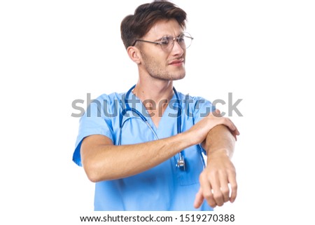 male young doctor shows in blue coat pain in hand