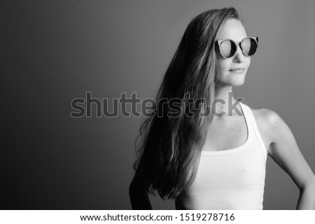 Young beautiful woman wearing sunglasses shot in black and white