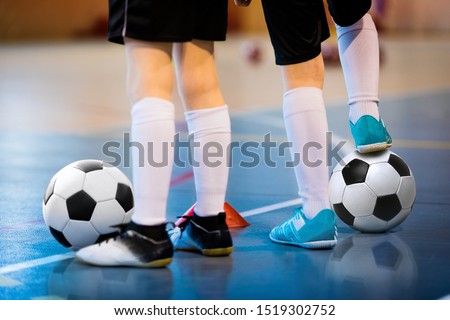 Futsal soccer training. Two young futsal players with balls on training. Close up of legs of futsal footballers Royalty-Free Stock Photo #1519302752