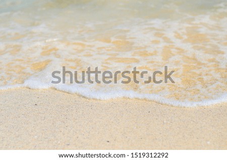 white wave on the sandy beach