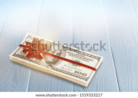 Money Gift Pack of 100 Dollars with a Red Bow - Isolated