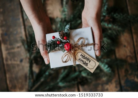 Top view of woman's hand holding Christmas gift