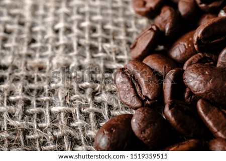 Coffee beans on burlap background. Macro.