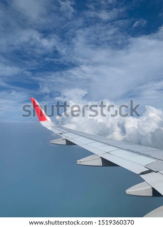 TRAVEL BY AIR PLANE WITH WING BLUE SKY