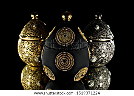black, gold, silver glass vessels for sugar in front view