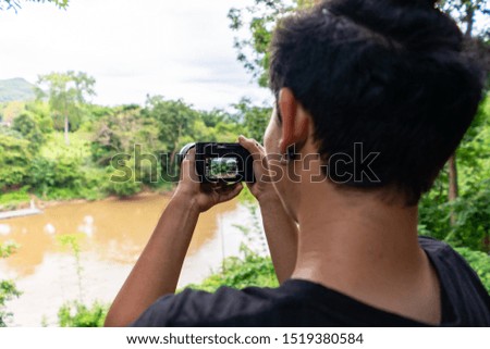 photographer in forest taking pictures.