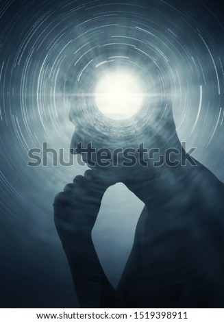 A silhouette of a man with rays of light emanating from the brain as a symbol of the power of thinking. Concept on the topic of psychiatry, psychology, religion, science, spiritual growth. Royalty-Free Stock Photo #1519398911