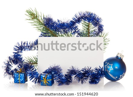 Fir-tree branch with tinsel, small gift boxes, a Christmas toy and a card isolated on white