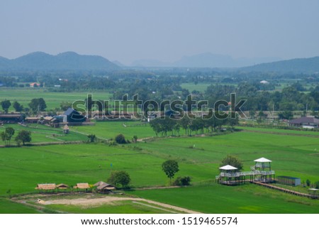 View of green fields and mountains at tiger Cave temple (Wat Thum Sua), Kanchanaburi, Thailand.
Soft and defocused.

