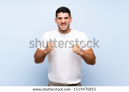 Caucasian handsome man over isolated blue background frustrated by a bad situation