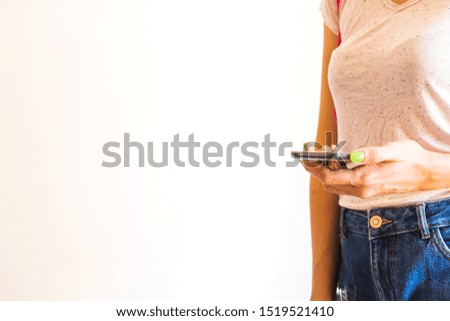 Young woman with mobile phone in hand. Closeup. Copy space