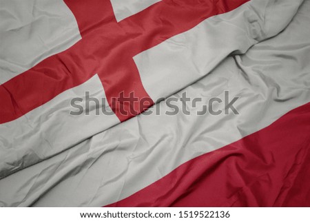 waving colorful flag of poland and national flag of england. macro
