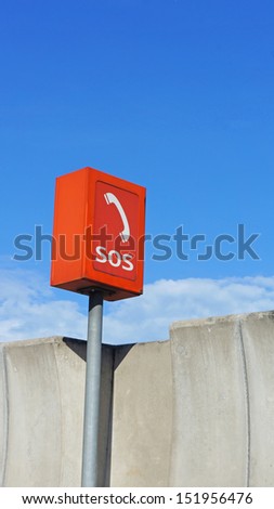 Orange SOS phone box at the highway