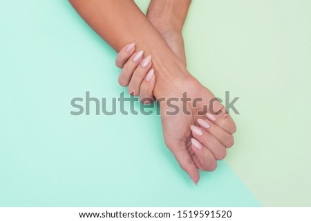 Stylish trendy female manicure. Beautiful young woman's hands on soft background.