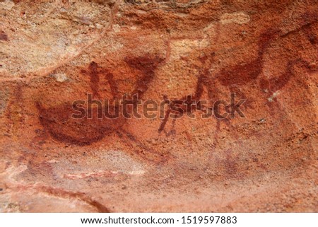Rock painting in the region of "Serra da Capivara" - State of Piaui - Northeast Brazil. The picture seems to depict hunters hunting deers.