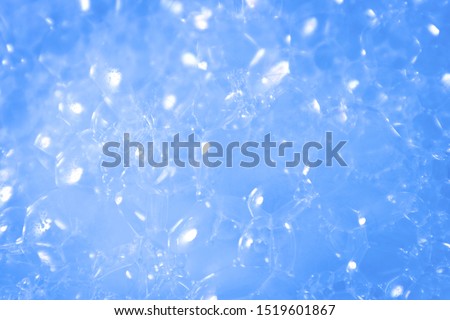 Beautiful abstract texture color white and blue bubbles background in water on blue background pattern clear soapy shiny