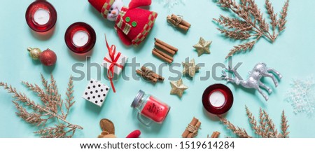 Christmas flat lay. Frame of golden Fir branches decorated with festive balls and Christmas decor on a blue mint mocap background with copy space, christmas background long banner