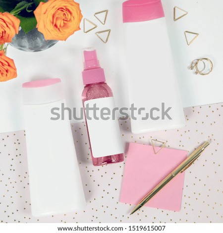 Plain mock up top view flat lay photography of cute girly skincare products in a beautiful composition with empty label for your design