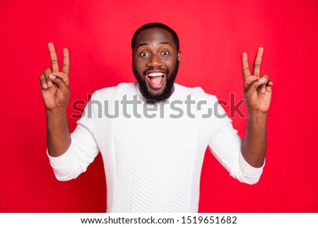 Portrait of funky crazy man have weekends make v-sign feel positive cheerful candid wear white trendy clothes isolated over red color background