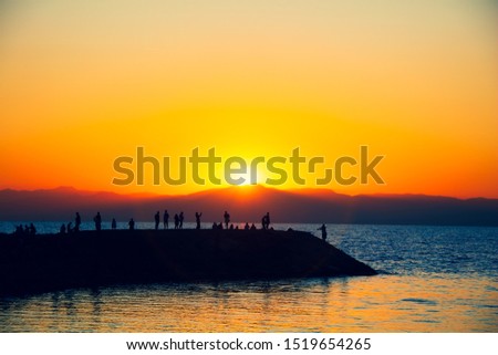 Silhouettes of people against the background of sunset