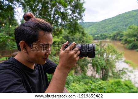 photographer in forest taking pictures.