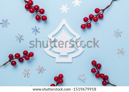 Christmas composition White fir tree, holly berries and snowflakes on pastel blue background. Christmas, winter, new year concept. Flat lay, top view, copy space - Image